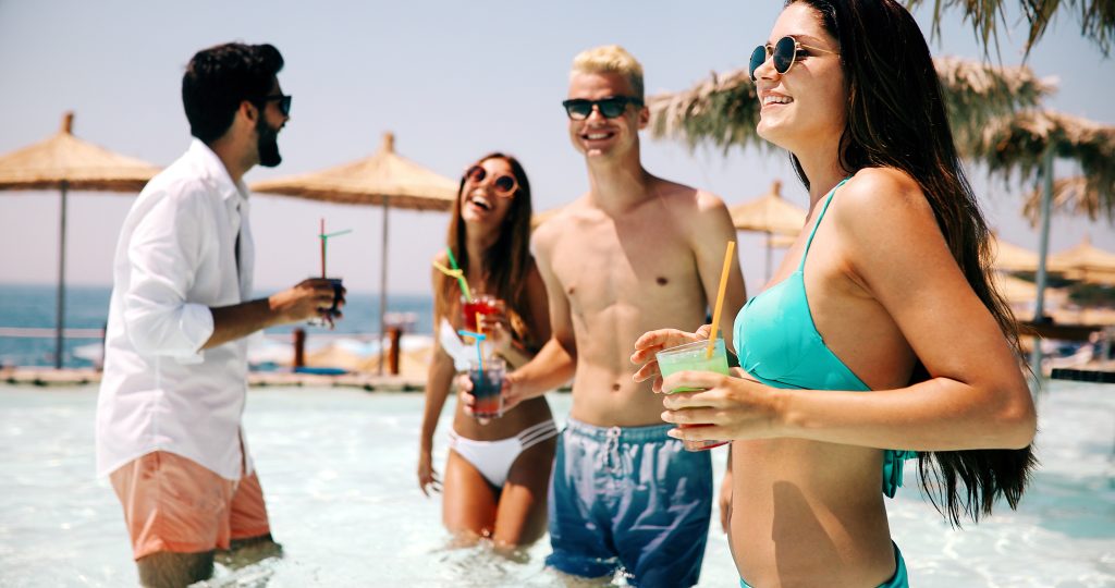multicultural group of happy friends partying on the beach during summer vacation